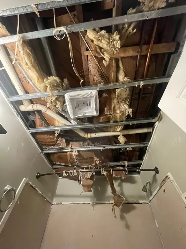 Ceiling opened to wet insulation and framing after a roof leak in Howard County