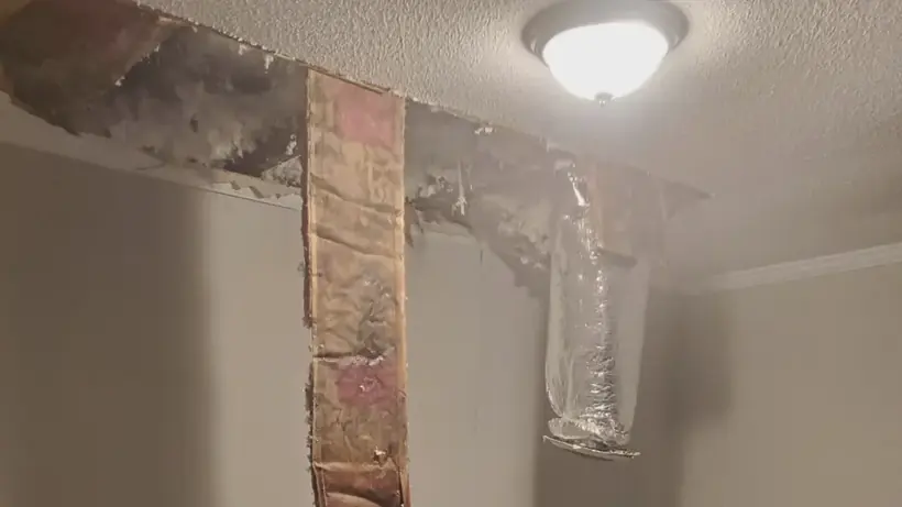 Water-stained wall and ceiling in a Columbia, MD townhouse